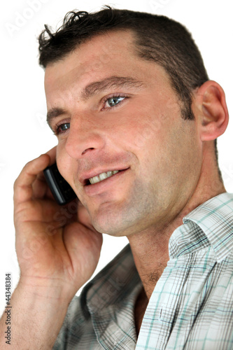Photo: Closeup of a man using a cellphone Closeup of a man using a cellphone