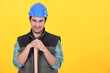 Man leaning on sledge-hammer handle