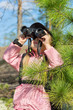 Child with binoculars looking up