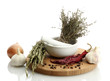 dried herbs in mortar and vegetables, isolatrd on white