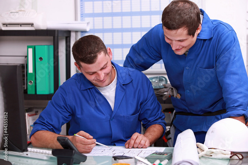 Photo: Laborers sharing a joke in the office Laborers sharing a joke in the office