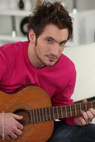 Photo: Man playing the acoustic guitar Man playing the acoustic guitar