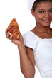 Baker holding a croissant