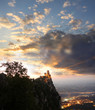 Castle in San Marino Republic above evening town, Italy