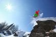 Skier jumping from the cliff in high mountains