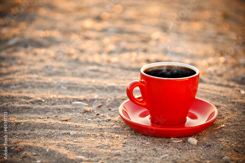 Photo: Coffee cup on sand Coffee cup on sand