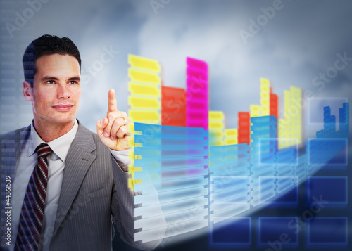 Photo: Businessman touching a holographic screen. Businessman touching a holographic screen.