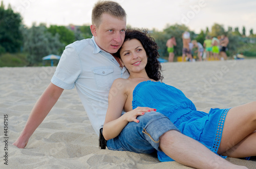 Photo: Young couple relaxing on a beach Young couple relaxing on a beach