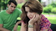 Relationship difficulties, couple sitting in park
