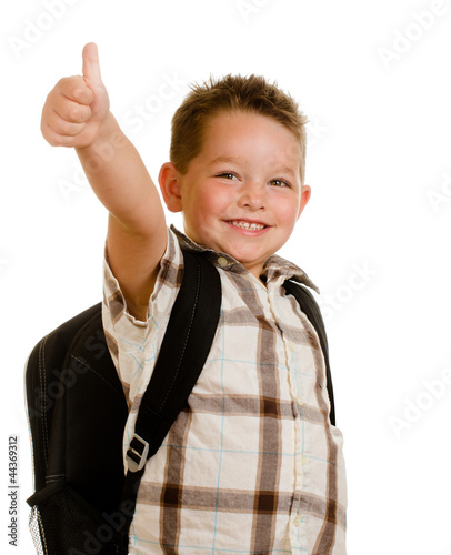 Photo: Happy schoolboy wearing backpack and giving thumbs up Happy schoolboy wearing backpack and giving thumbs up