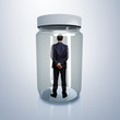Businessman inside glass jar