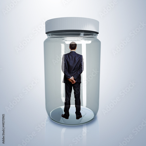 Photo: Businessman inside glass jar Businessman inside glass jar