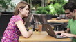 Video: Happy couple with laptop drinking wing in cafe, steadicam shot Happy couple with laptop drinking wing in cafe, steadicam shot