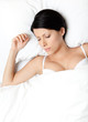 Sleeping woman in the queensize bed, white background