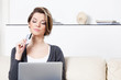 Pretty woman makes purchases through the internet