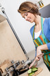 Young girl in striped apron cuts vegetables
