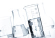 Group of classic laboratory flasks with a clear liquid