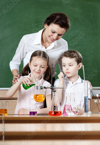 Photo: Little pupils study chemical liquids with their teacher Little pupils study chemical liquids with their teacher