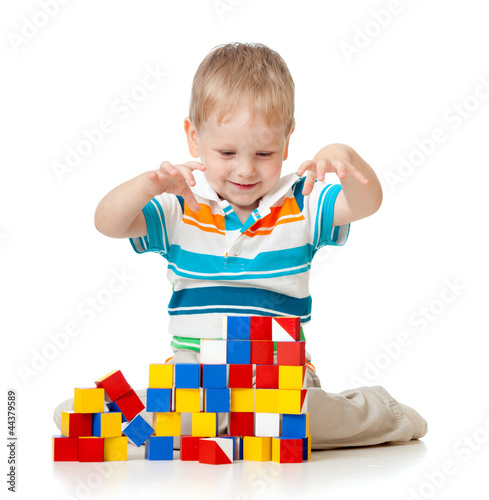 Photo: kid playing toy blocks isolated on white background kid playing toy blocks isolated on white background