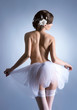 A young brunette ballet dancer posing in sexy white lingerie
