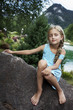 Beautiful girl relaxing on the rock
