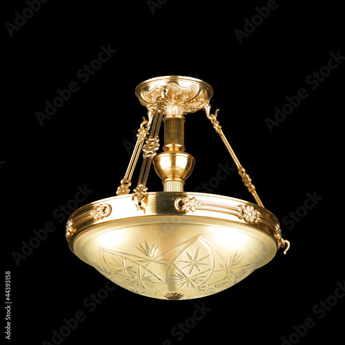 Photo: Vintage chandelier isolated on black Vintage chandelier isolated on black