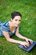 Closeup of a student  using her laptop outdoors at campus