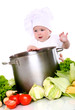 Cute baby chef with big pot and vegetables