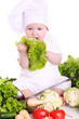 Cute baby chef with different vegetables