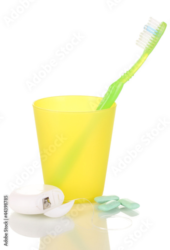 Photo: Toothbrush, chewing gum and dental floss isolated on white Toothbrush, chewing gum and dental floss isolated on white