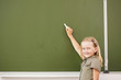 Photo: Scoolgirl standing near blackboard Scoolgirl standing near blackboard