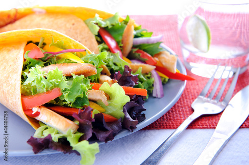 Photo: Vegetable burrito with chicken and cutlery Vegetable burrito with chicken and cutlery