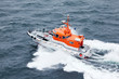 Photo: White boat floats in sea, white foam and spray on blue water White boat floats in sea, white foam and spray on blue water