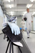 Close up of foil, mask and white glove at background of fencer
