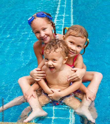 Photo: two little girls and little boy playing in the pool two little girls and little boy playing in the pool