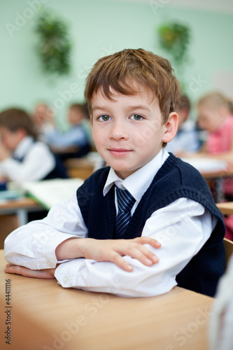 Photo: Diligent student sitting at desk, classroom Diligent student sitting at desk, classroom
