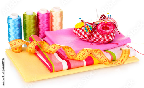 Photo: Sewing accessories and fabric isolated on white Sewing accessories and fabric isolated on white