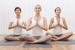 Interracial Group of Three Beautiful Women In Yoga Position