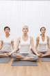 Interracial Group of Three Beautiful Women In Yoga Position