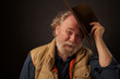 Friendly old bearded  outdoors man tipping his hat