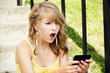 Shocked young blond reading text