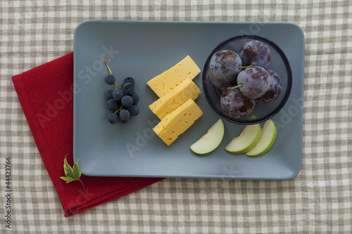 Photo: Cheese and fruit plate with red napkin Cheese and fruit plate with red napkin