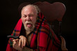 Old man leans forward and sticks out his tongue