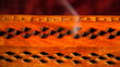 Incense stick in a wooden holder with red silk background, artit