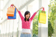 happy young asian girl shopping at complex