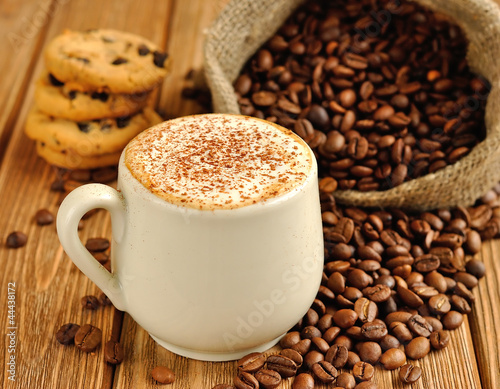 Photo: Coffee with froth and coffee beans in a sack Coffee with froth and coffee beans in a sack