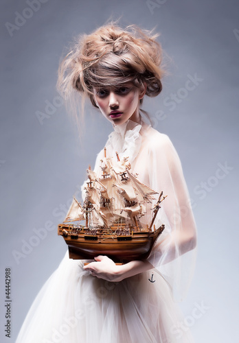 Photo: Creative art. Sophisticated woman in white vintage dress Creative art. Sophisticated woman in white vintage dress