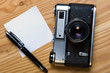 old rangefinder camera with memo and pen