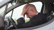 Sad businessman sitting in the car