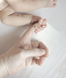 baby's hand gripping parent's hand